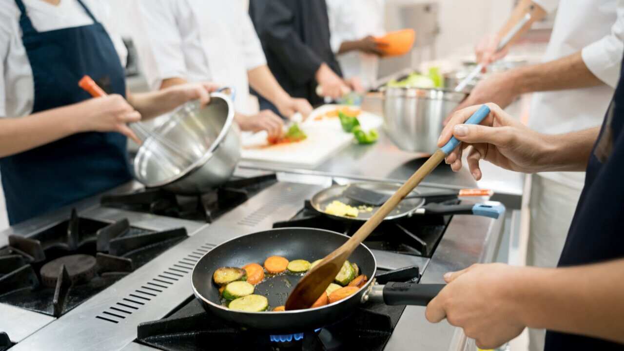 Unrecognizable people at a restaurant cooking meals