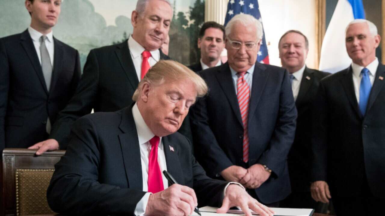 US President Donald J. Trump (C) signs an order recognizing Golan Heights as Israeli territory,