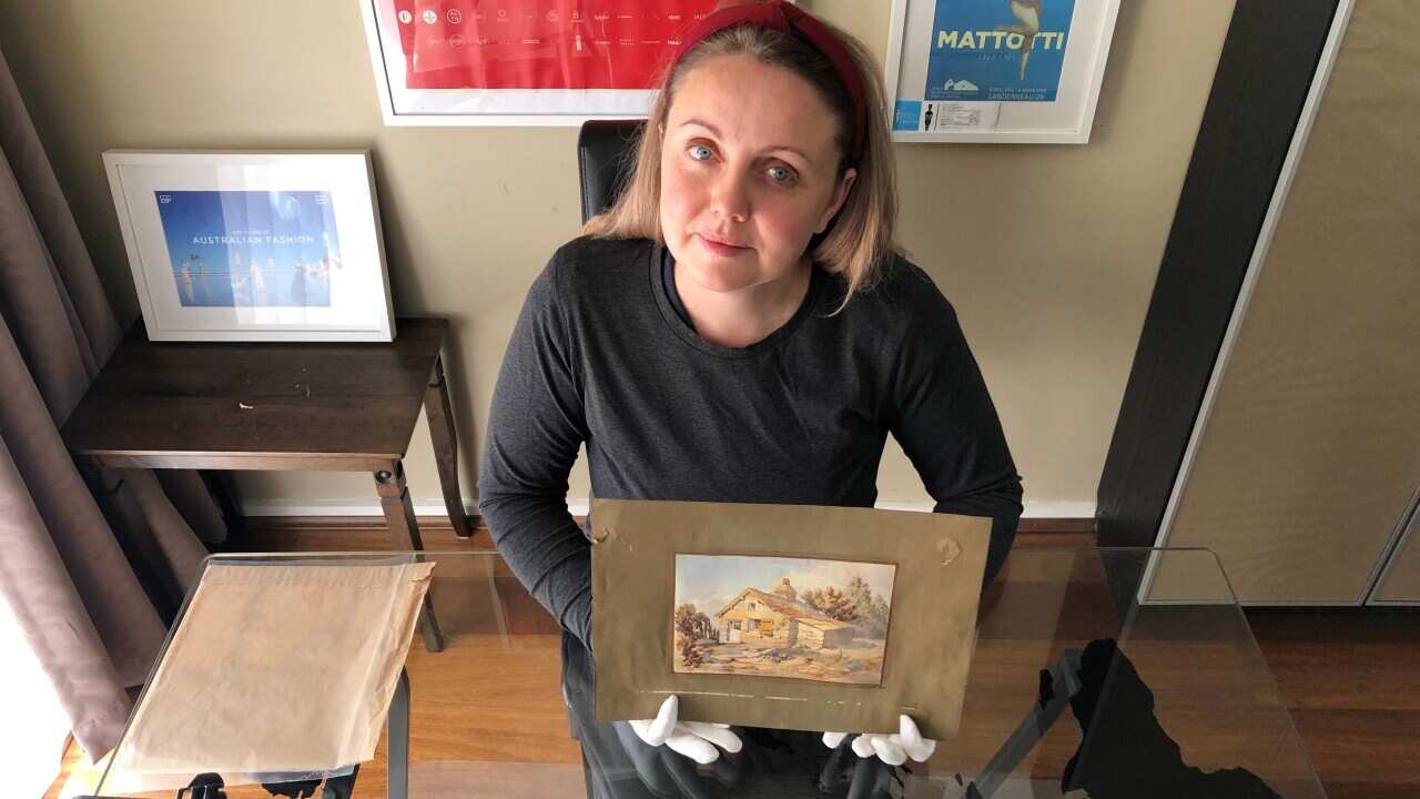 Anna Anisimova with a watercolor painting made by John James Clark