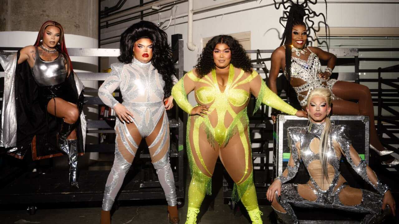 Five performers posing in leotards and performer costumes. 