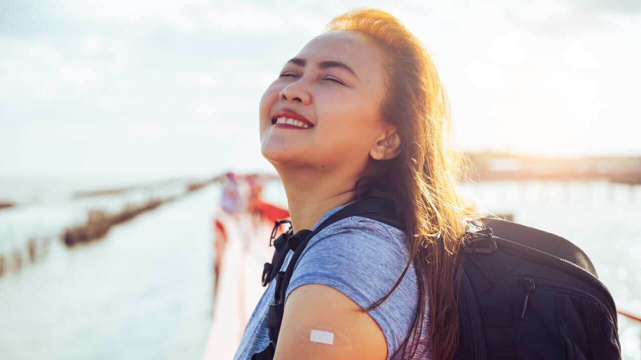 the happiness emotional of the woman when her traveling after vaccination during COVID-19 pandemic