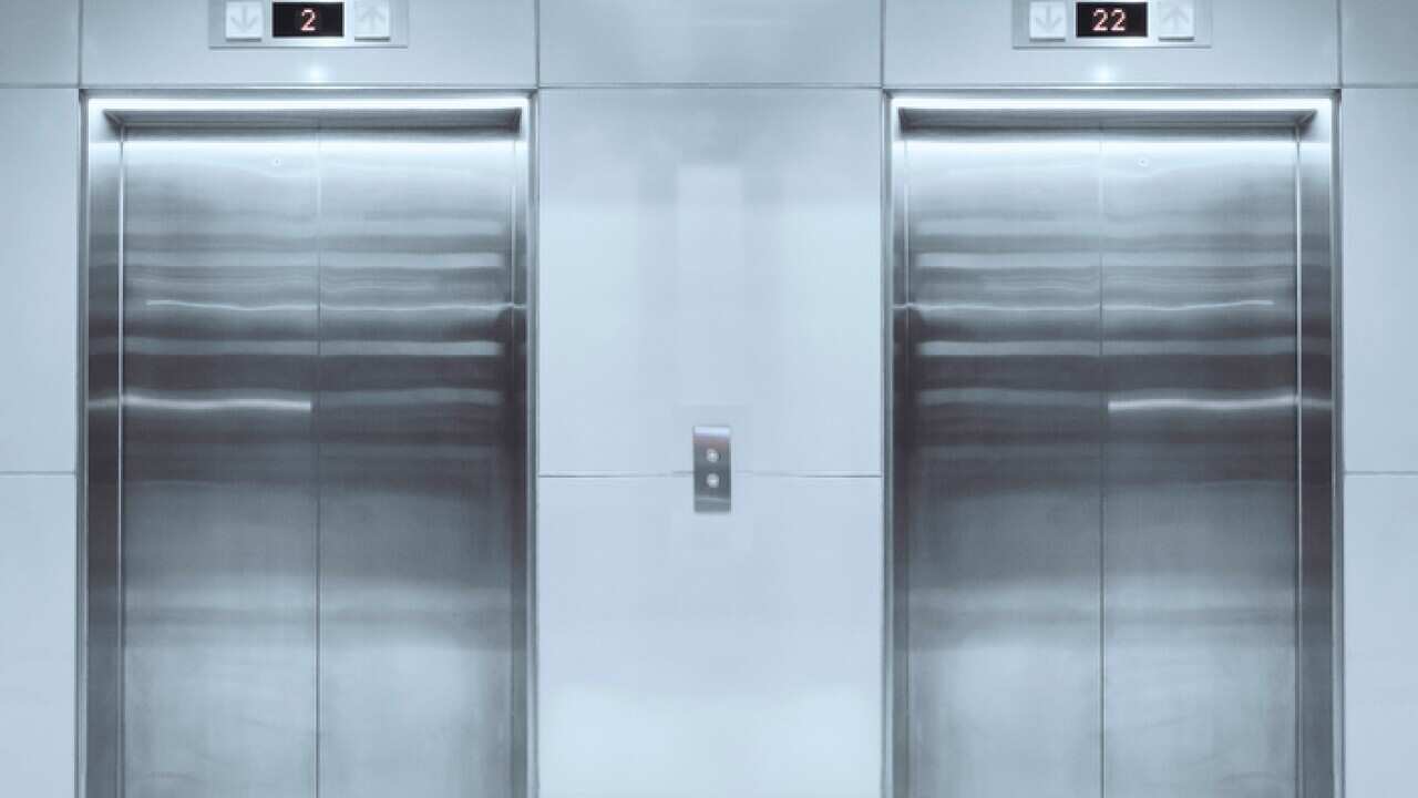 Modern elevator with closed doors in lobby