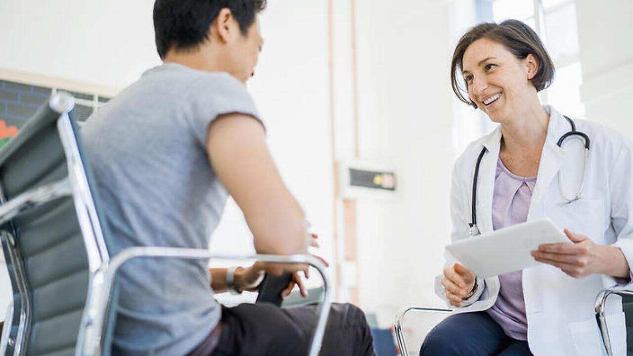 Happy female doctor with patient in hospital