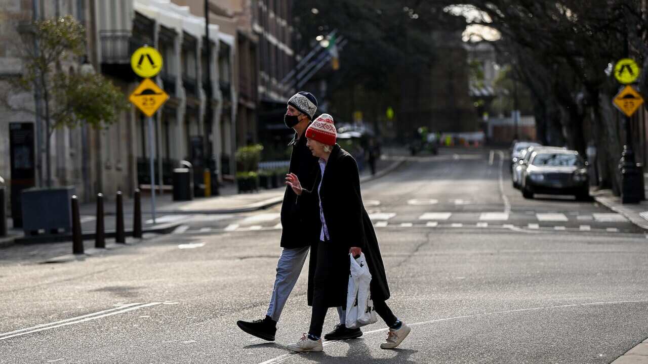 People cross an empty street in The Rocks, Sydney, Thursday, July 8, 2021. NSW has recorded 38 new locally acquired COVID-19 cases overnight, the highest daily number of new cases in 14 months. (AAP Image/Bianca De Marchi) NO ARCHIVING