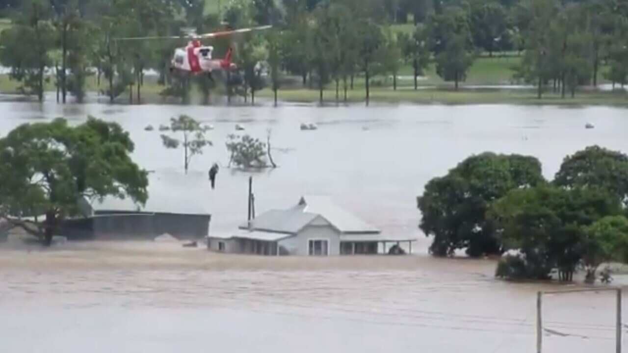 NSW RFS crews rescue people from rising floodwaters. 