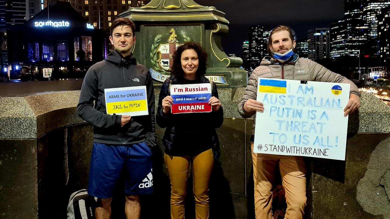 Daniel Mitchell (R) with anti-Putin protestors at Princes Bridge, Melbourne.