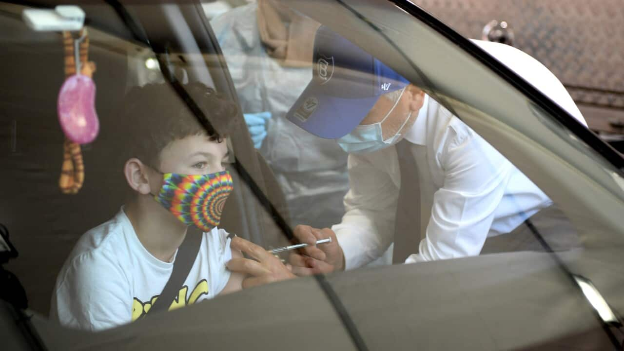 Dr Jamal Rifi administers a Covid vaccine to 12 year old Bailee Little at a pop-up drive through vaccination clinic at Belmore Oval, in Sydney, Friday, September 17, 2021. 