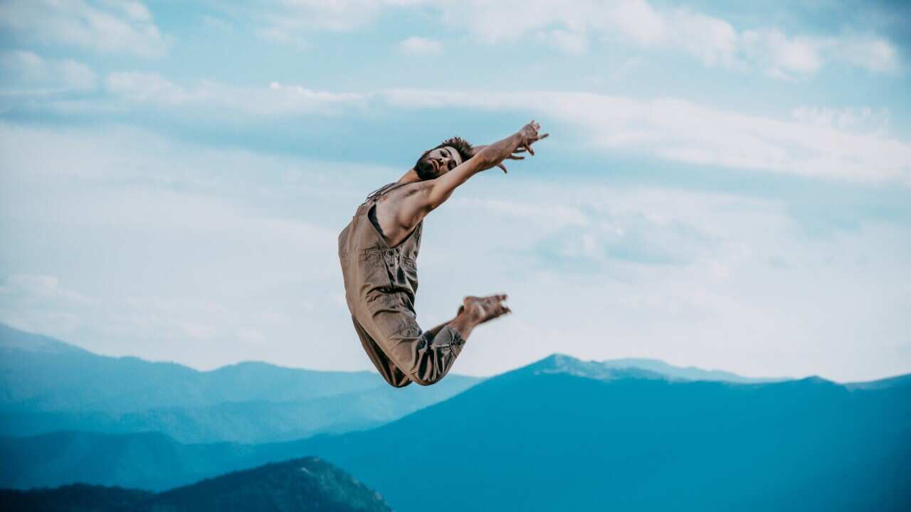 Modern slim hip-hop style man jumping dancing