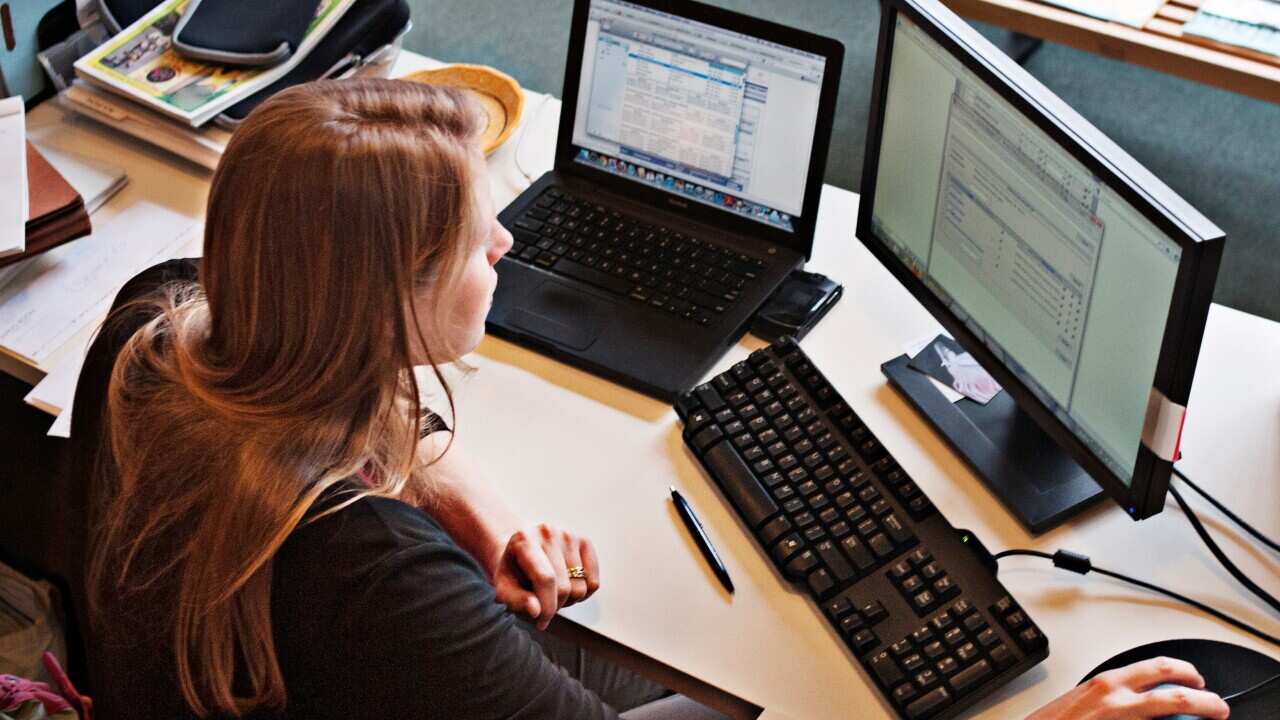 A woman working at office computer