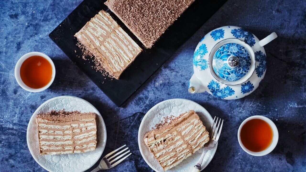 Bosnian biscuit cake served in slices, with hot tea