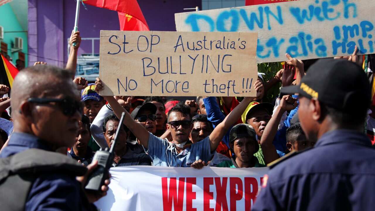 East Timorese students hold placards during a protest outside the Australian embassy in Dili, East Timor, also known as Timor Leste, 22 March 2016. 