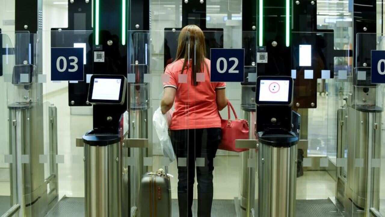A passenger uses an automated passport control channel