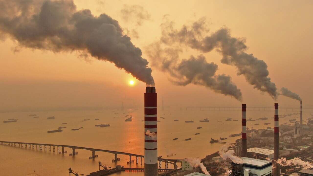 The sun sets near a coal-fired power plant on the Yangtze River in Nantong in eastern China's Jiangsu province