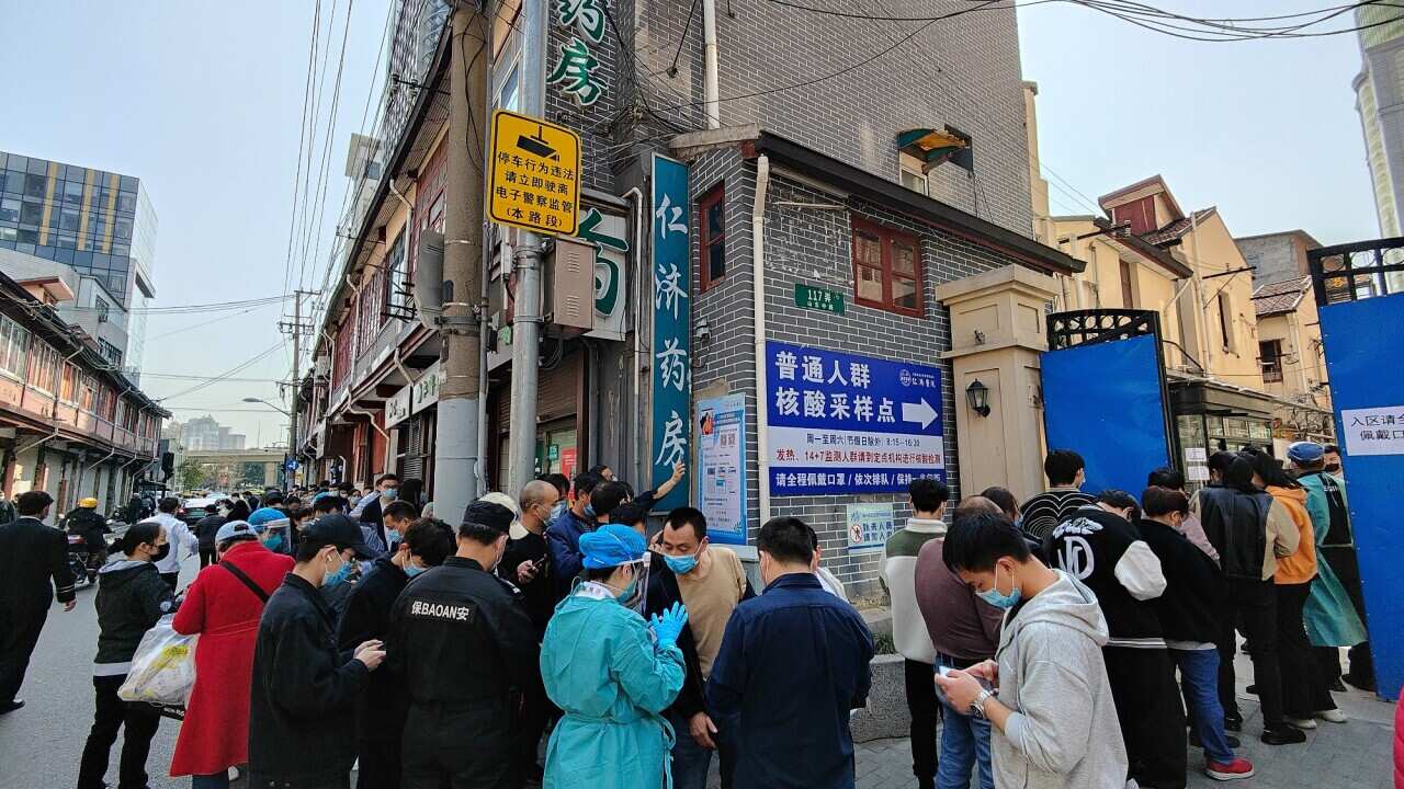 Hundreds of people queue outside a COVID-19 testing clinic in Shanghai, China, on 11 March 2022.