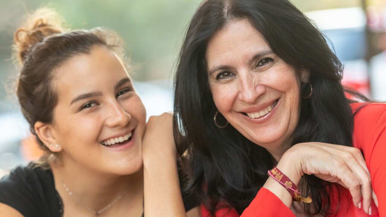 Mature woman posing with her daughter