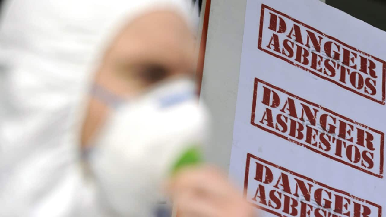 Protesters wearing protective asbestos equipment