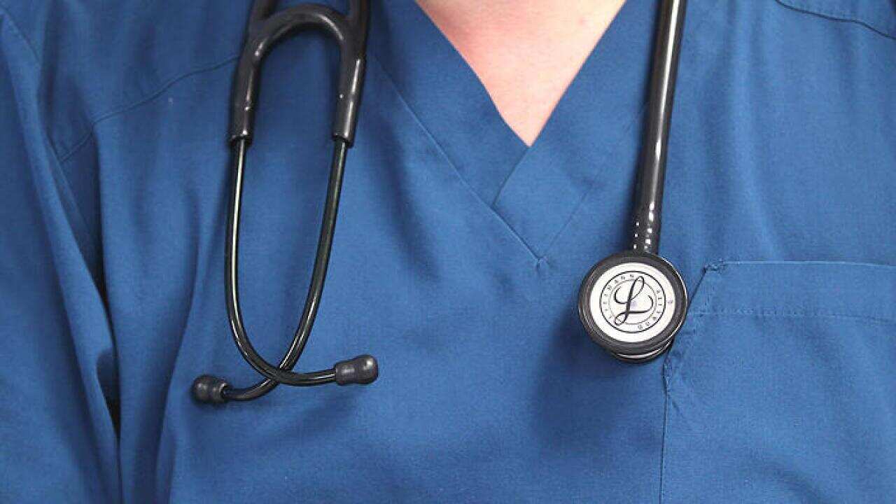 A Doctor holds a stethoscope at the Royal Liverpool University Hospital, Liverpool