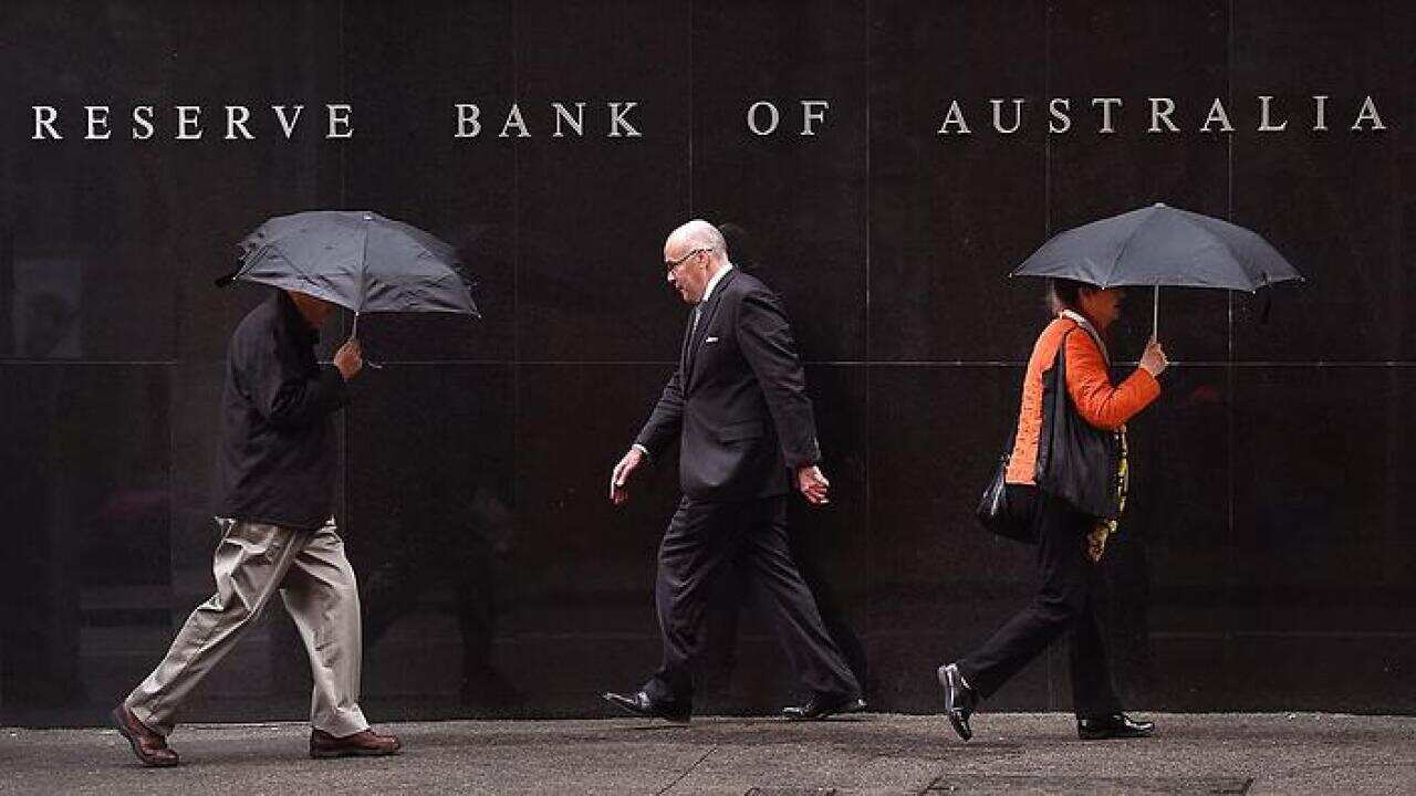 People walk past the Reserve Bank of Australia sign in Sydney 