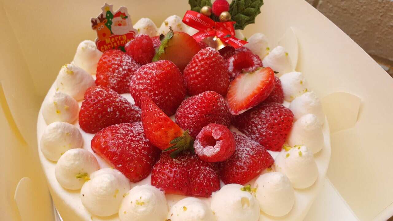 Japanese cream shortcake decorated with strawberries and Christmas holly 