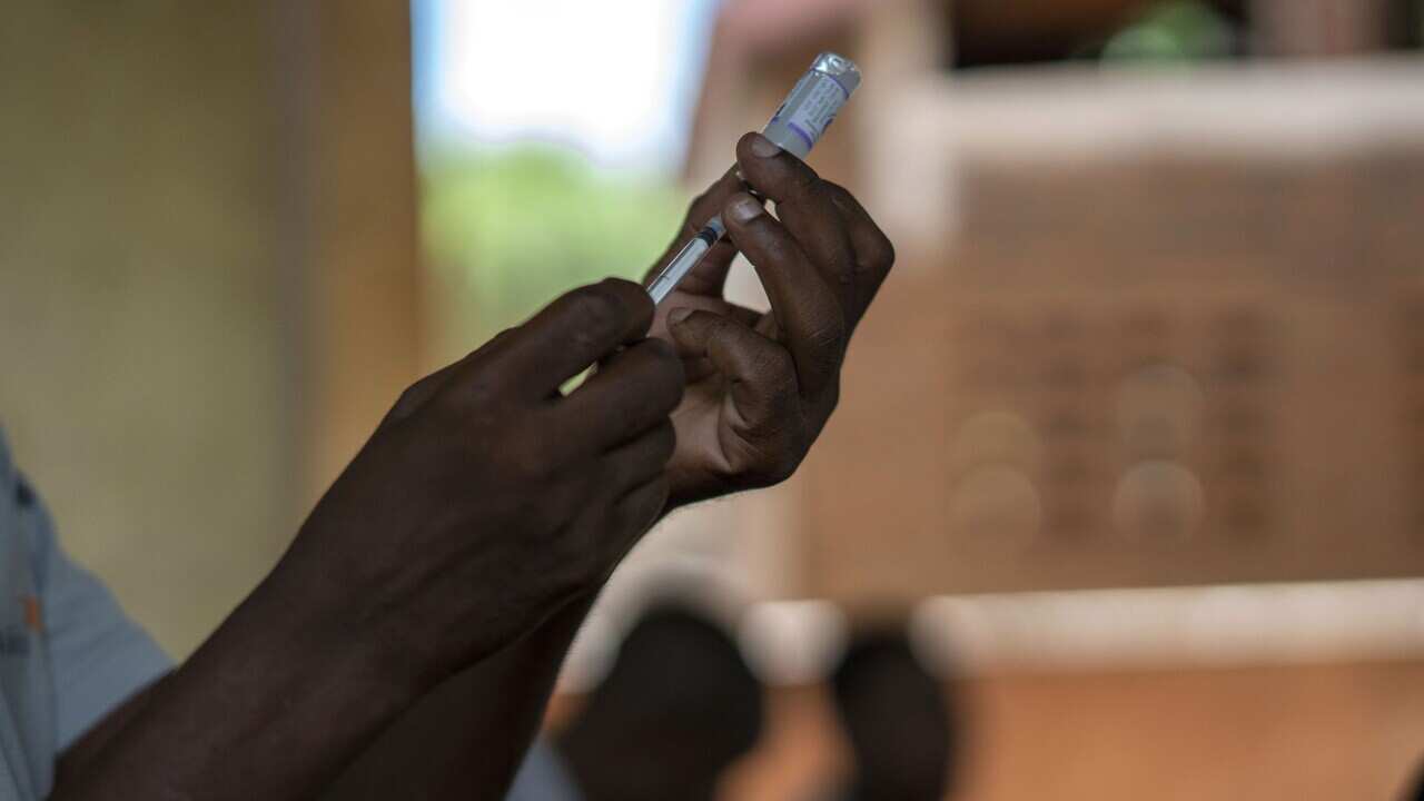 Health officials prepare vaccines in the Malawi village of Tomali in December 2019, where children were test subjects for the world's first malaria vaccine. 