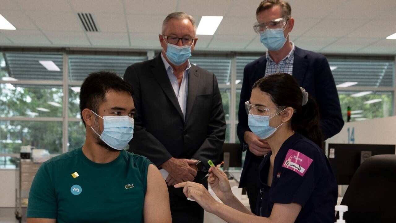 NSW Premier Dominic Perrottet and Brad Hazzard, Minister for Health and Medical Research NSW observe booster shots being administered during a visit to the Sydney Olympic Vaccination Hub.