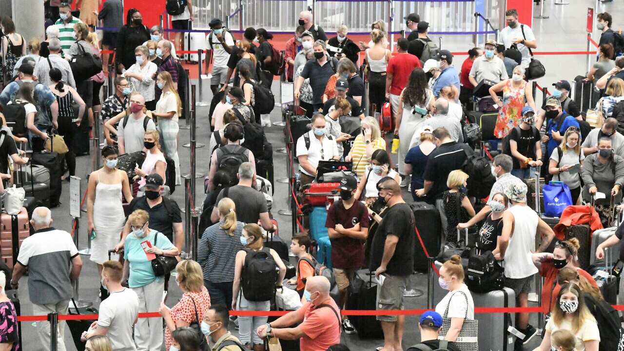 Passengers check in for flights out of  Brisbane, Monday, March 29, 2021. Greater Brisbane will enter a snap three-day lockdown as its coronavirus outbreak continues to grow.(AAP Image/Dave Hunt) NO ARCHIVING, EDITORIAL USE ONLY