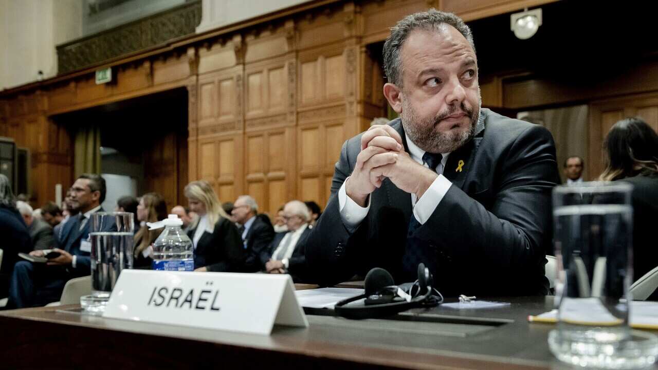 Tal Becker, legal counsellor for Israel, sits behind a desk in the courtroom. 