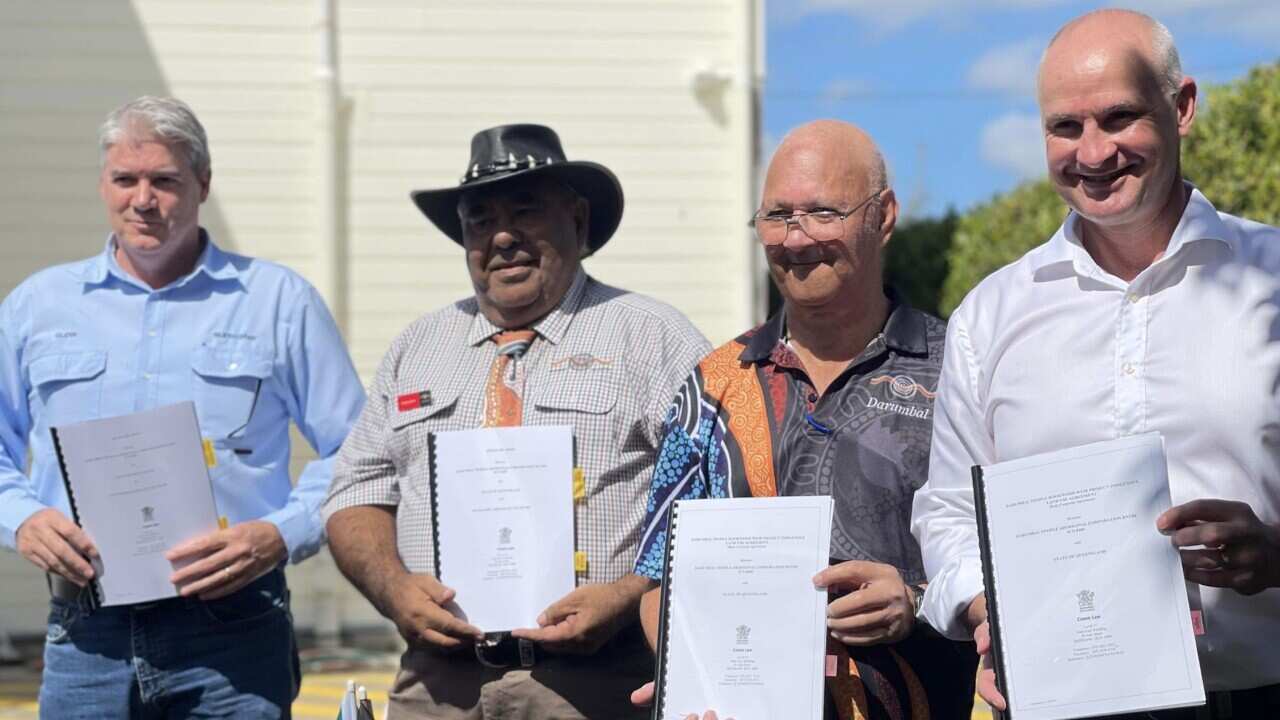 Sunwater CEO Glenn Stockton (far left) and Minister for Water Glenn Butcher (far right) with Darumbal traditional custodians