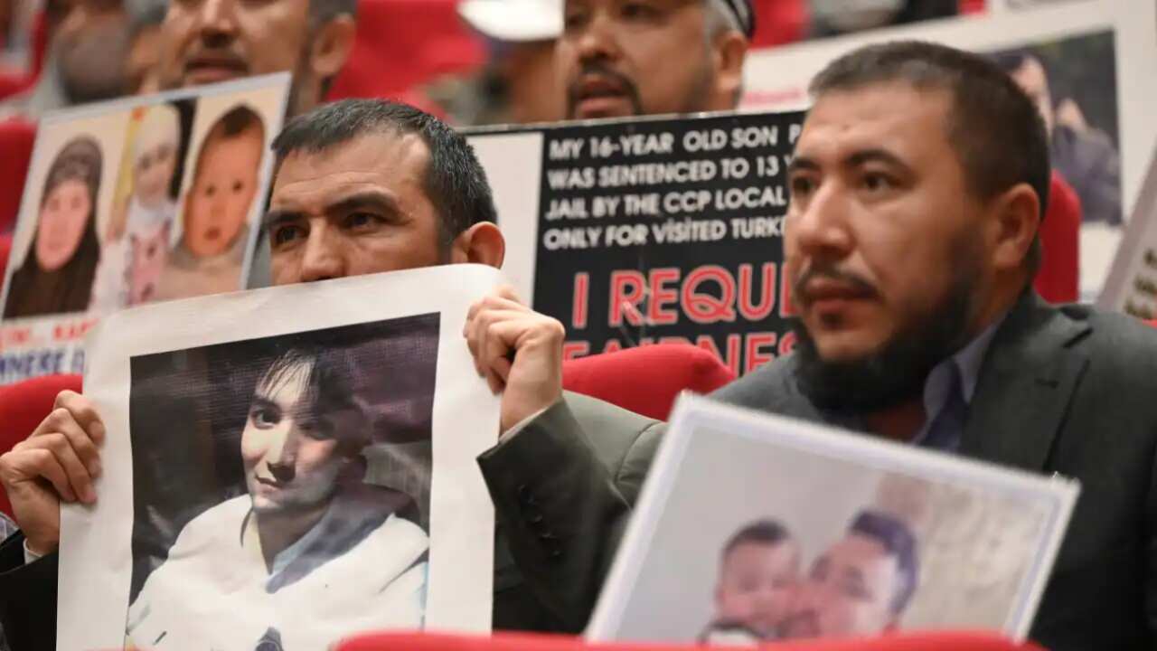 Members of Muslim Uyghur minority present pictures of their relatives detained in China during a press conference in Istanbul, on 10 May 2022