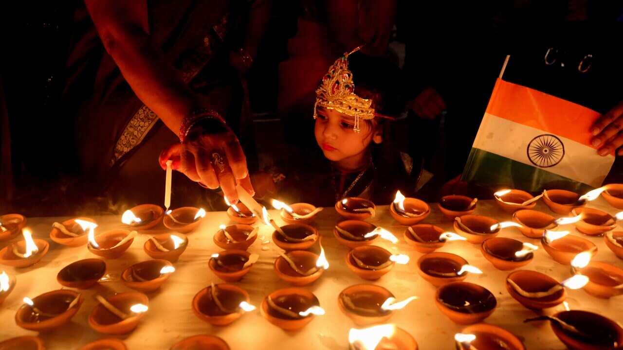 People light lamps at a temple on the occasion of Diwali, or the Festival of Lights, in Bhopal, India, 13 November 2020. 