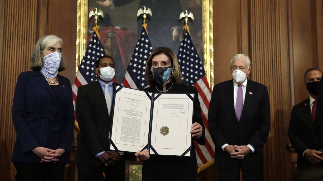 House Speaker Nancy Pelosi signs the article of the impeachment against President Donald Trump.