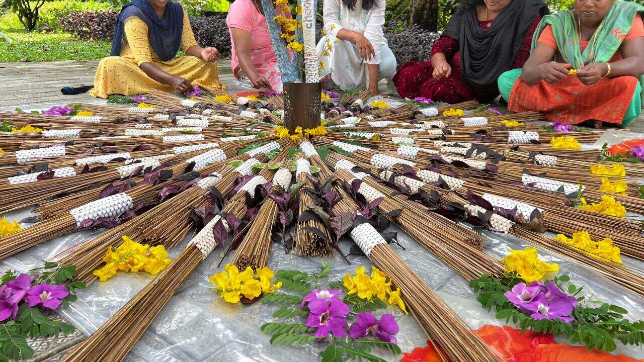 Lakshmi Menon with her workers and designer broom