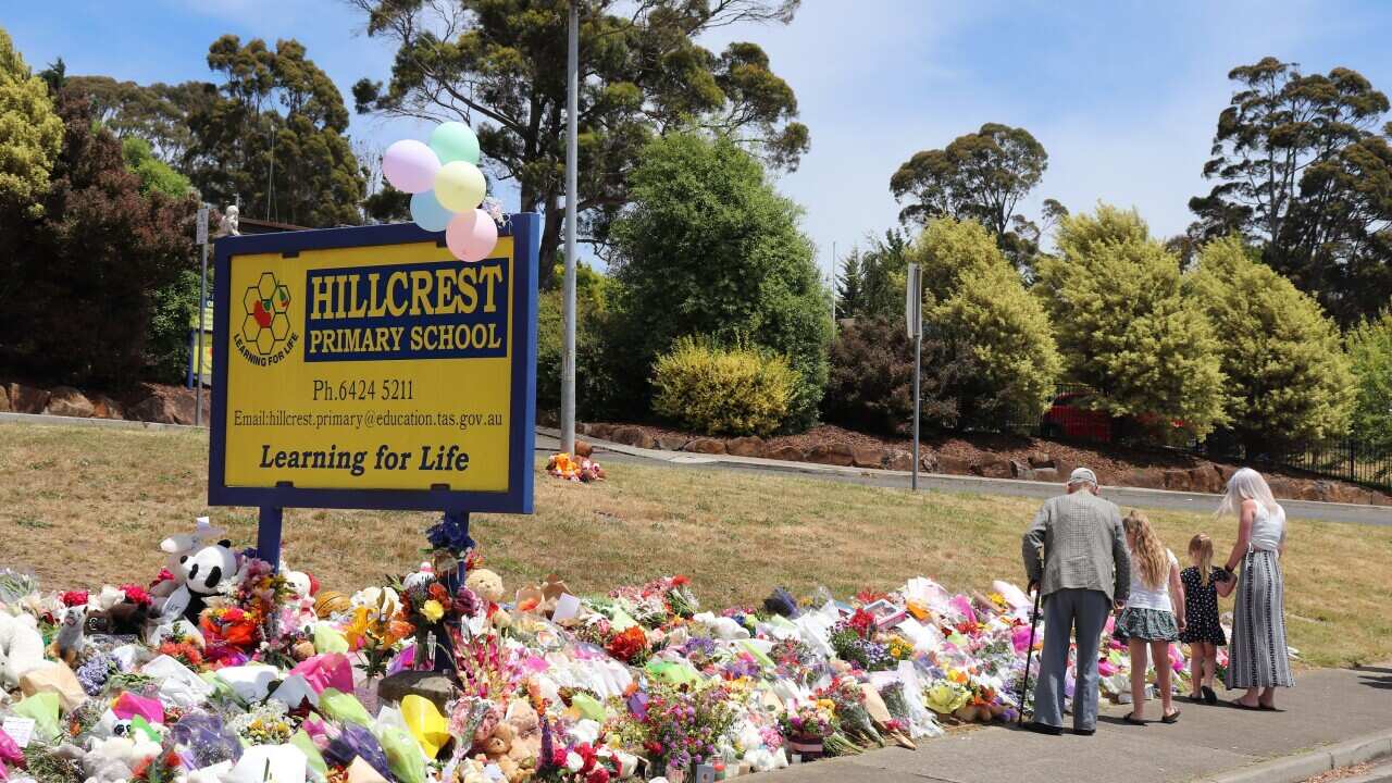 People leave flowers and tributes outside Hillcrest Primary School in Devonport