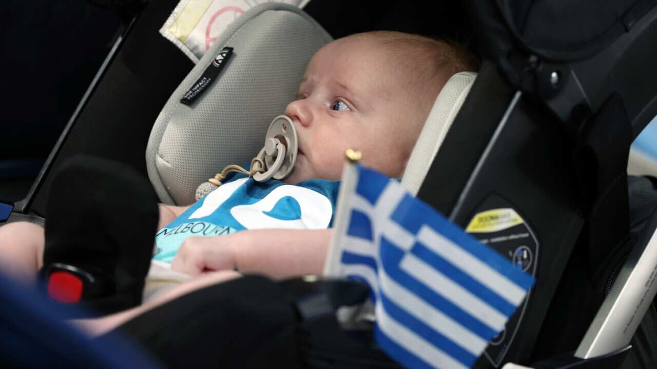 A baby is seen with a Greek flag at Melbourne's Australian Open tournament