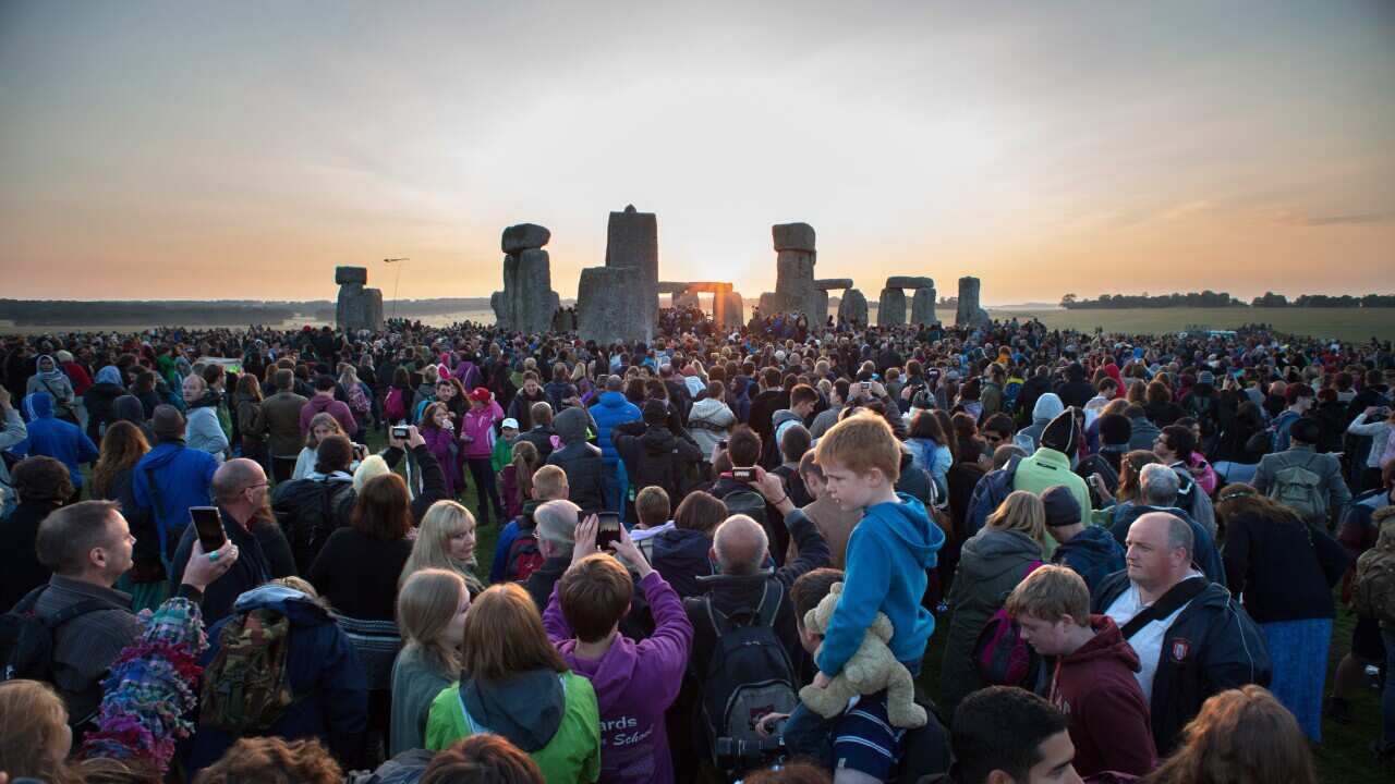 A crowd of people at Stonehenge 