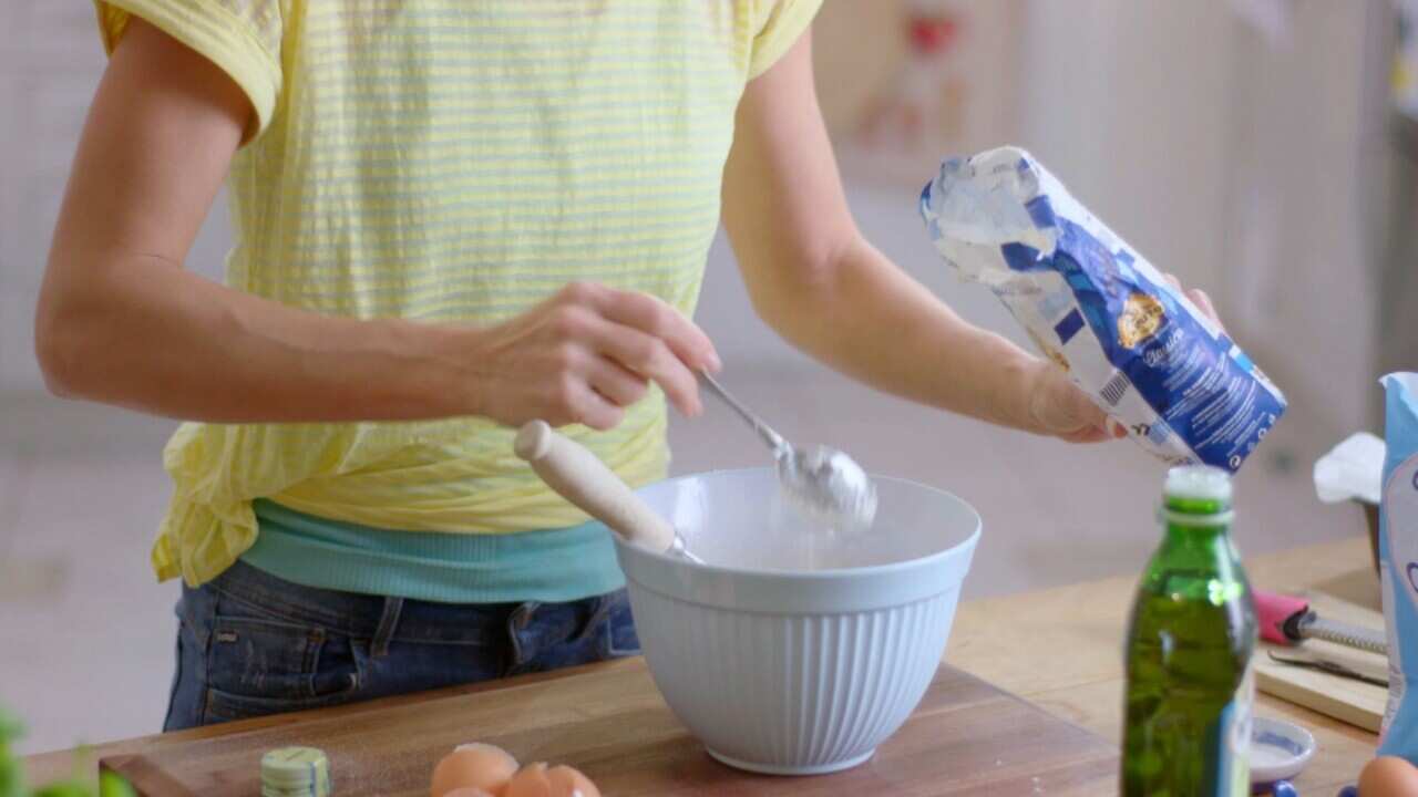 Spooning flour into bowl