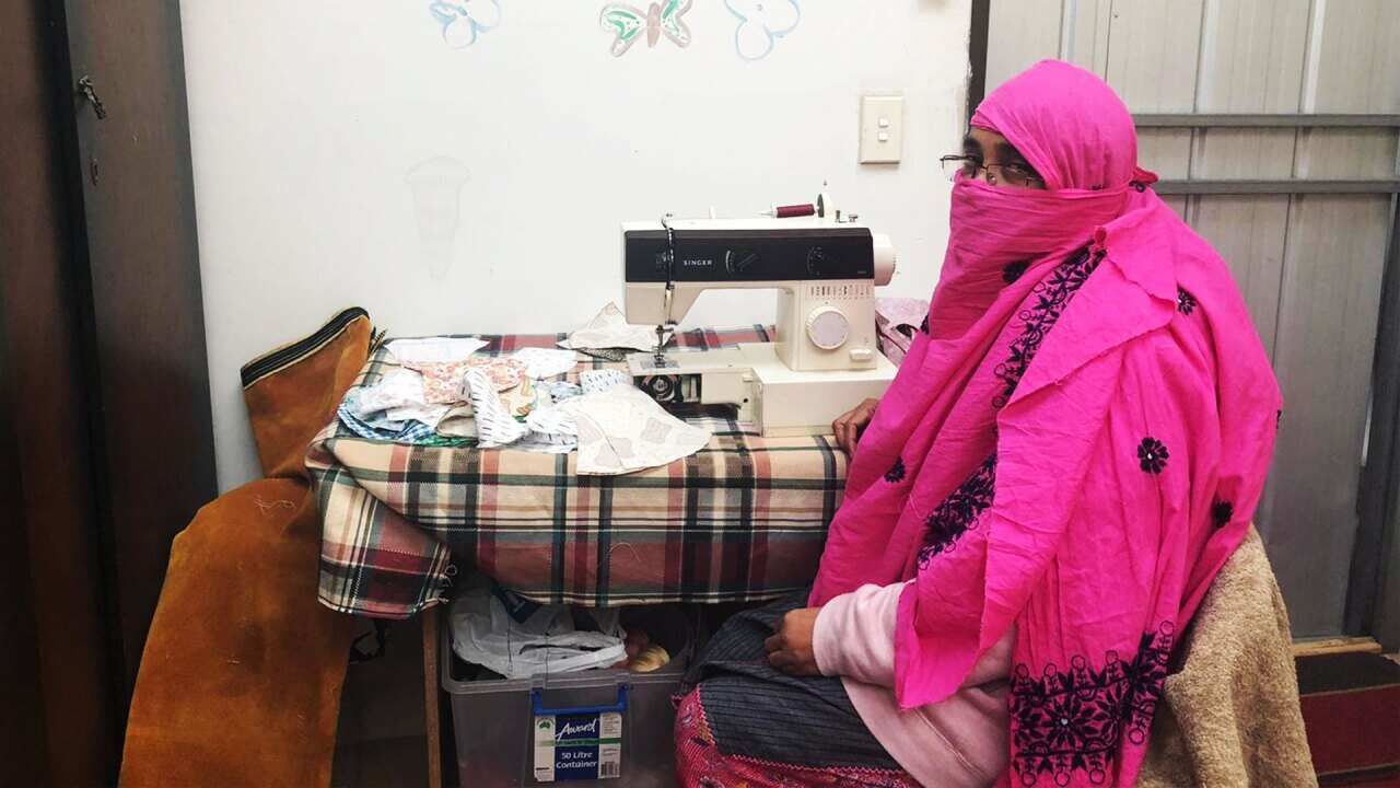 SisterWorks employee Nur making reusable face masks from her home. 