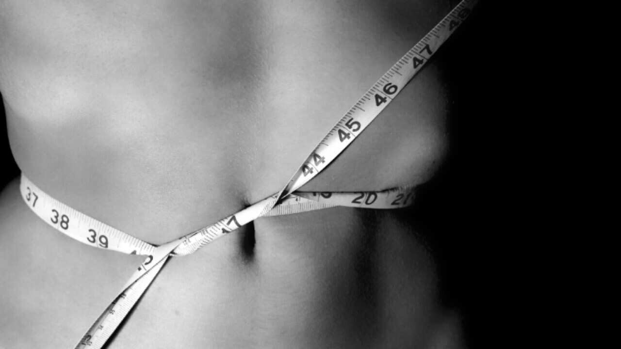 Torso wrapped in measuring tape