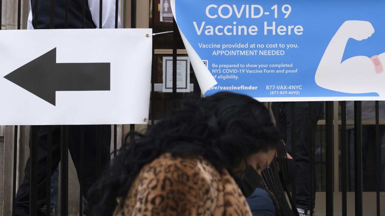 People walk past a COVID-19 vaccine distribution site in New York City, USA, 22 January 2021.