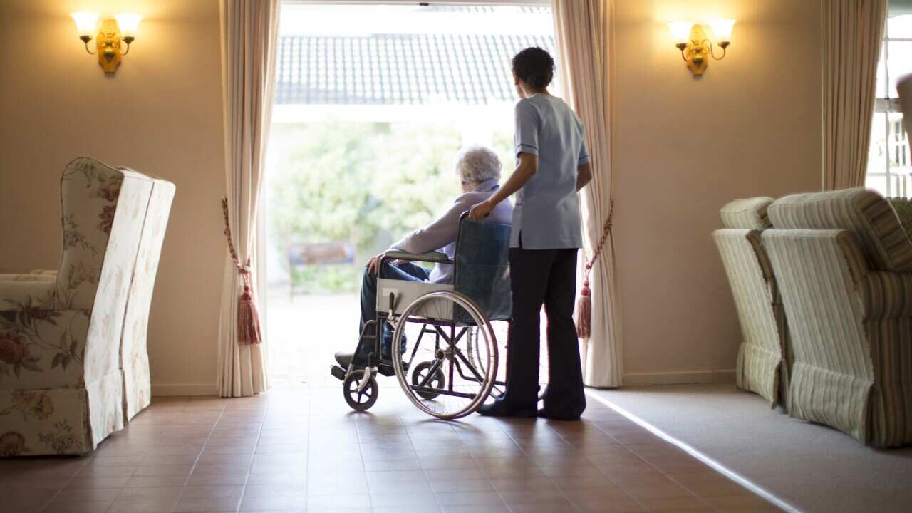 Nurse pushing patient in wheelchair