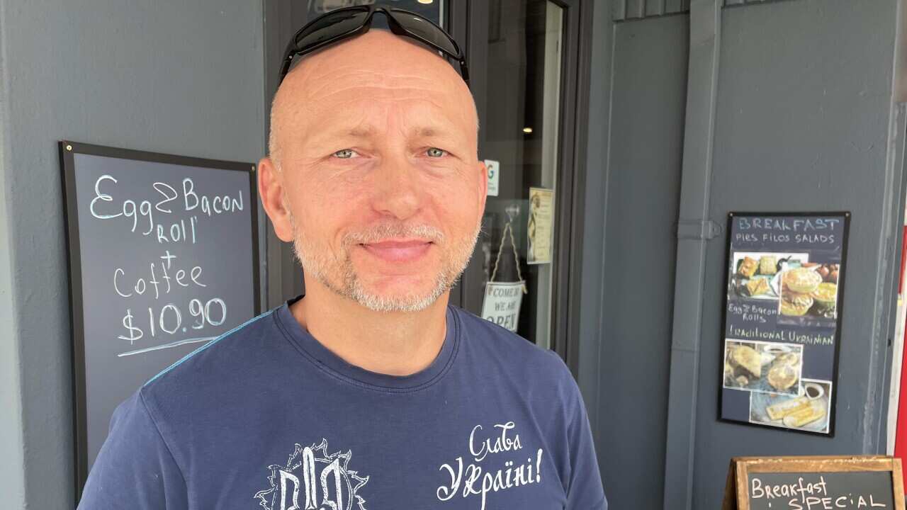 Oleg Sutulov standing outside Mavka cafe.