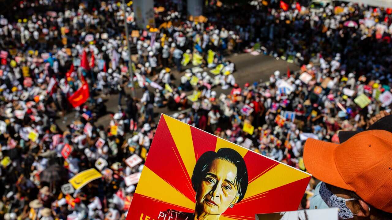 Protesters block a major road during their campaign against the military coup