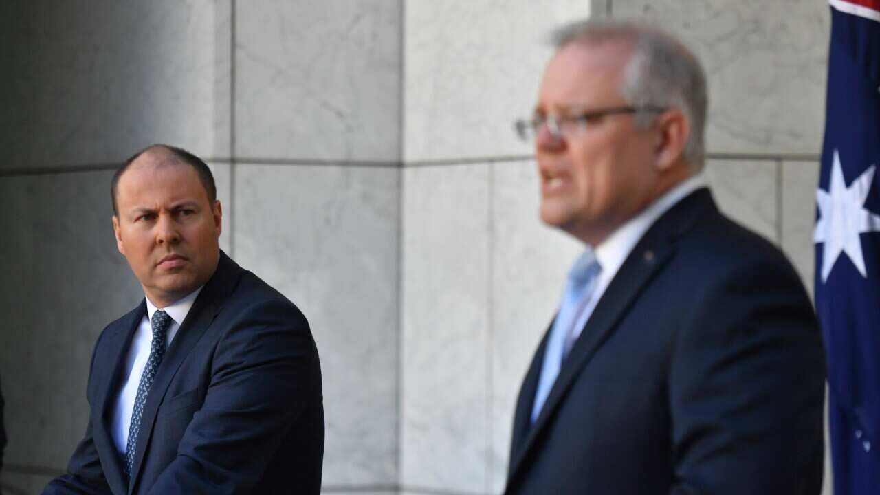 Treasurer Josh Frydenberg and Prime Minister Scott Morrison at a press conference to announce the government's coronavirus stimulus package at Parliament House in Canberra, Sunday, March 22, 2020. (AAP Image/Mick Tsikas) NO ARCHIVING