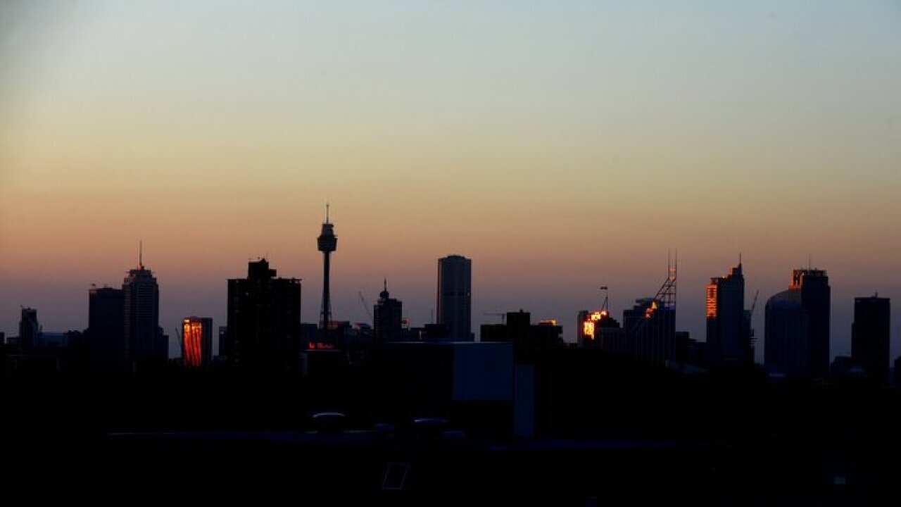 The sun reflects off of the CBD as it sets over Sydney, Monday, Jan. 31, 2011. Sydneysiders are being urged to stay cool and keep out of the sun, with the mercury tipped to soar dangerously over coming days. (AAP Image/Tracey Nearmy) NO ARCHIVING