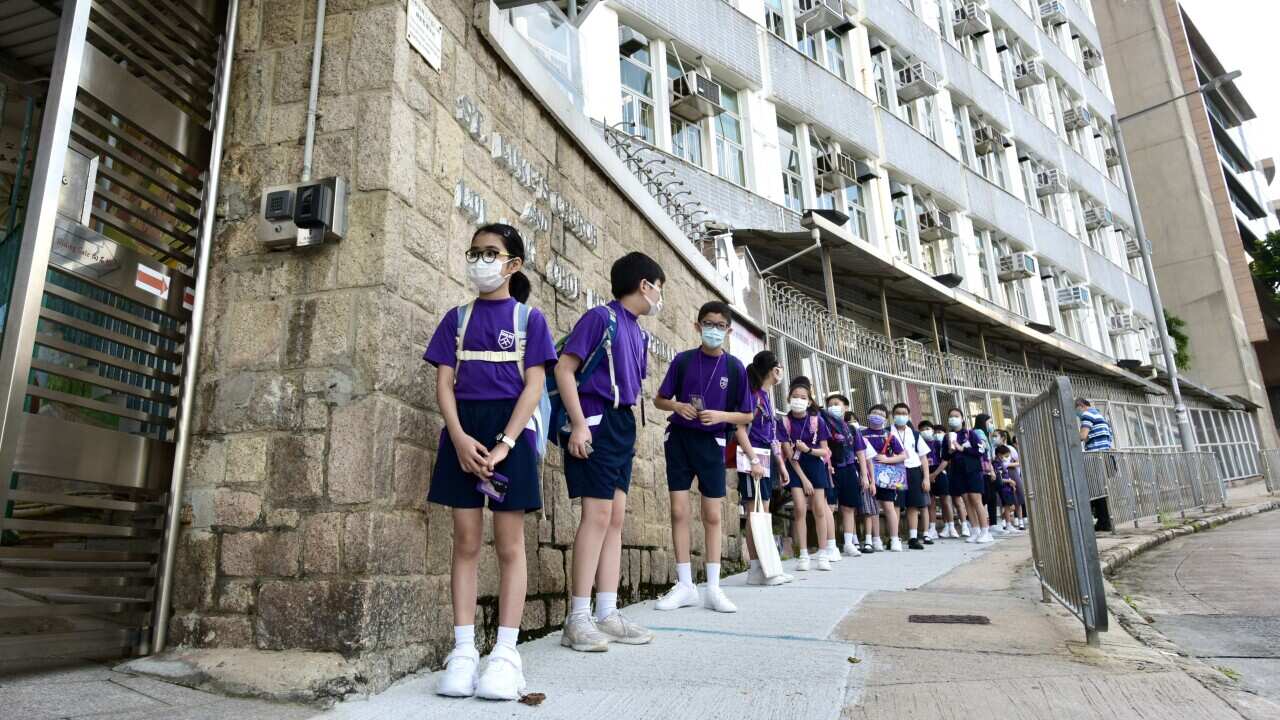 Children queue outside a school in Hong Kong, China on September 22, 2020.