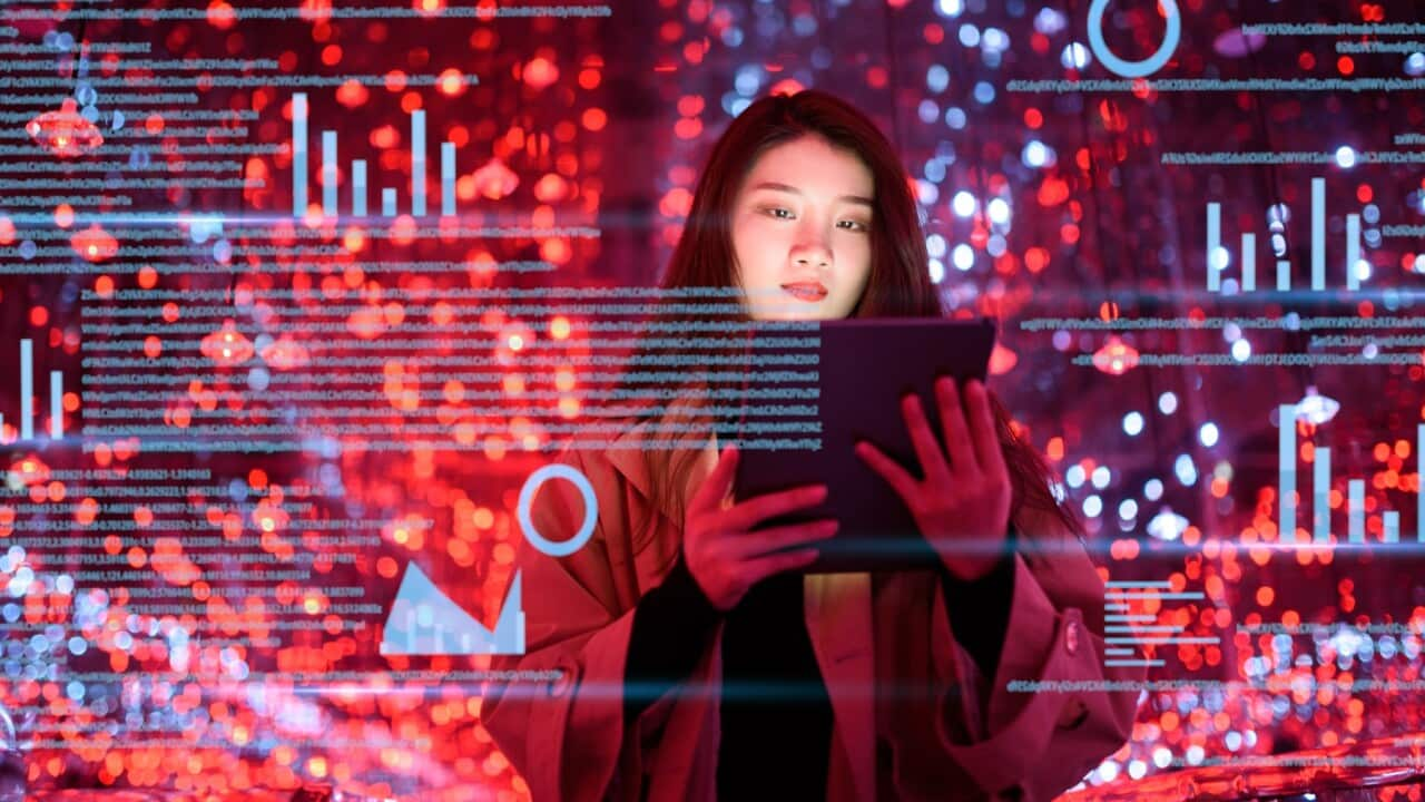 Young woman uses visual tablet at night 