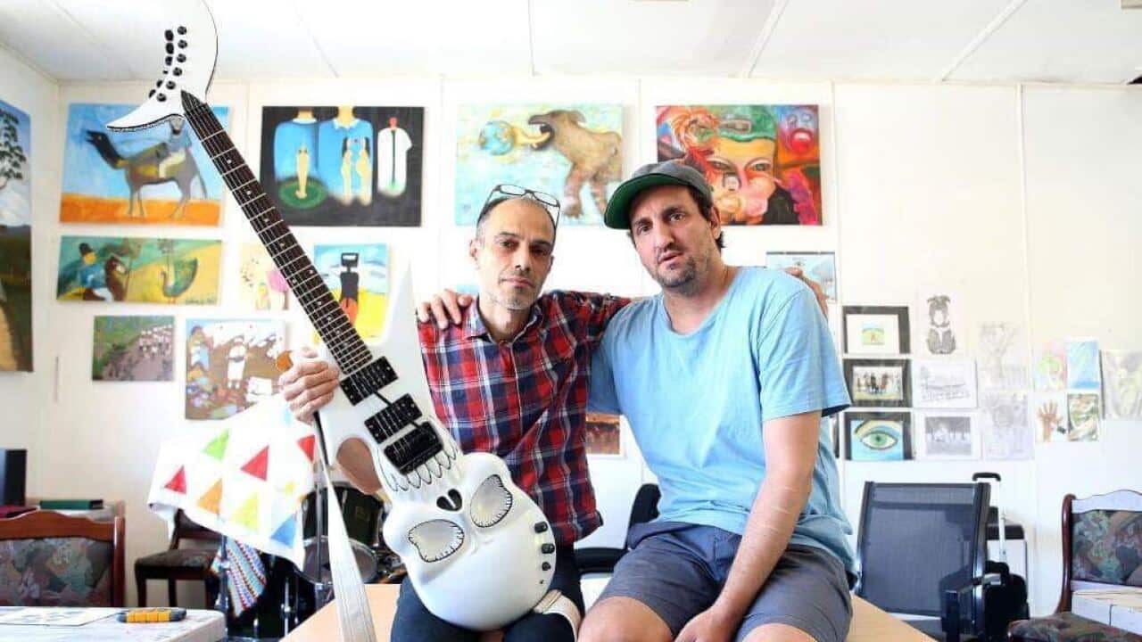 Safdar Ahmad with Majid Rabet posing with Majid's hmemade eclectrpnic guitar