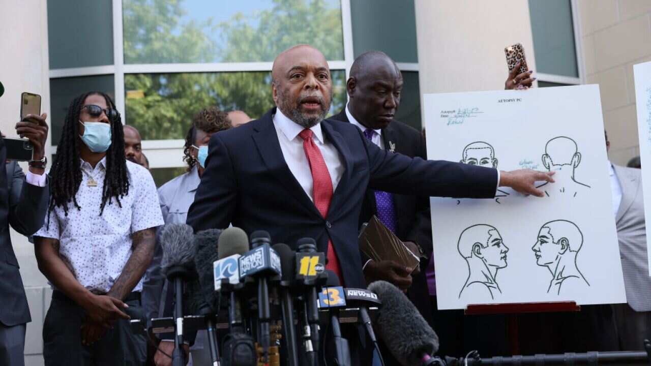 Wayne Kendall, one of the lawyers representing the family of Andrew Brown Jr., points to an autopsy chart showing where Mr Brown was shot by police.