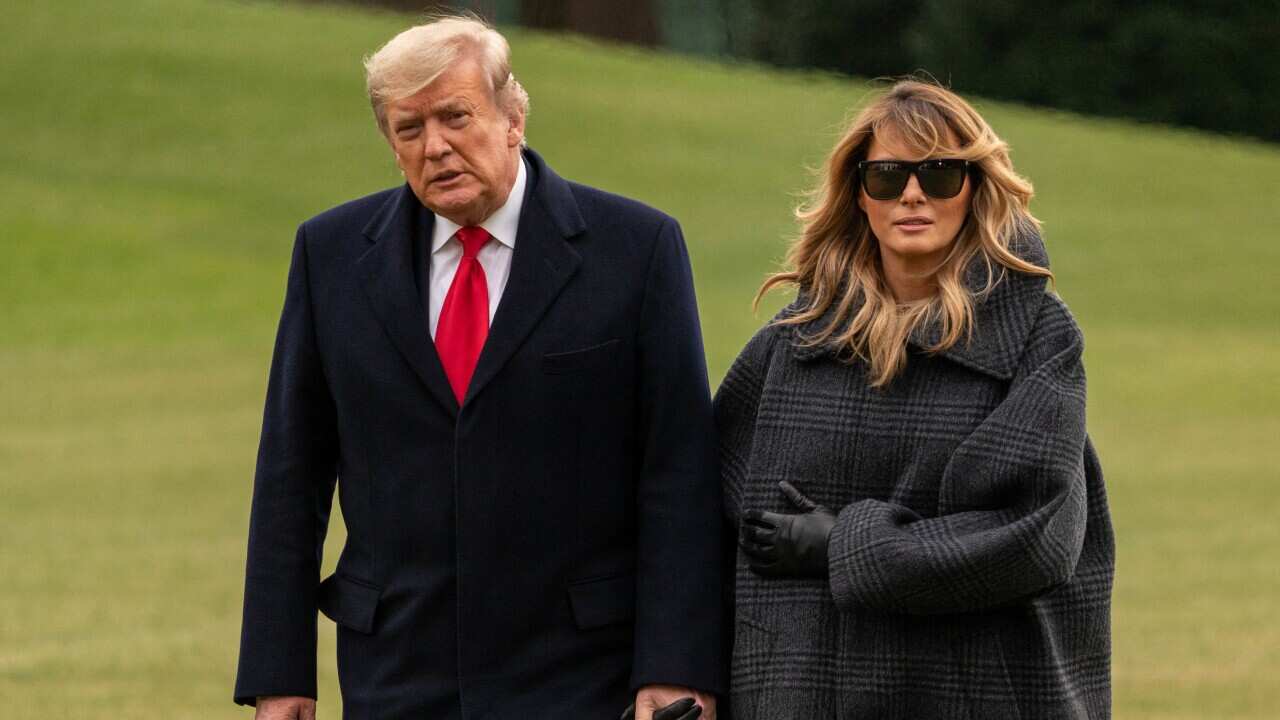 US President Donald Trump and First Lady Melania Trump return from their Florida vacation early at the South Lawn of the White House on 31 December.