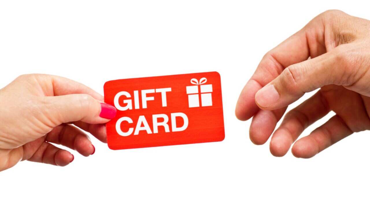 Hands Giving and Receiving Retail Gift Card on White Background